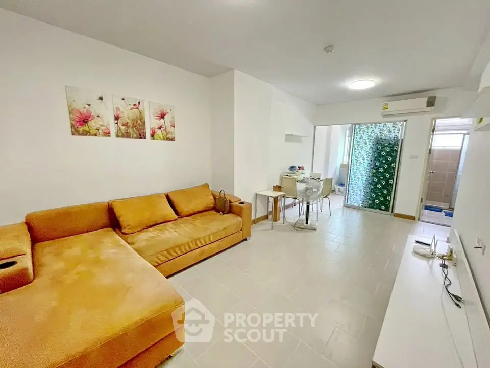 Spacious living room with modern decor and cozy sectional sofa in a bright apartment.