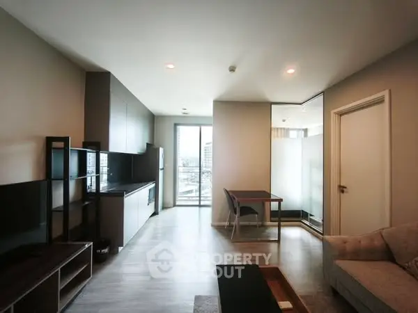 Modern living room with open kitchen and balcony view