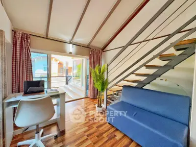 Modern living room with loft design, featuring sleek staircase and abundant natural light.