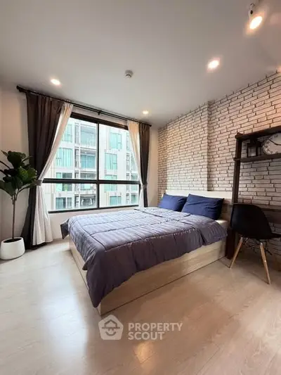 Modern bedroom with stylish brick wall and large window view