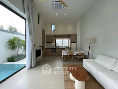 Modern open-plan living room with pool view and stylish kitchen