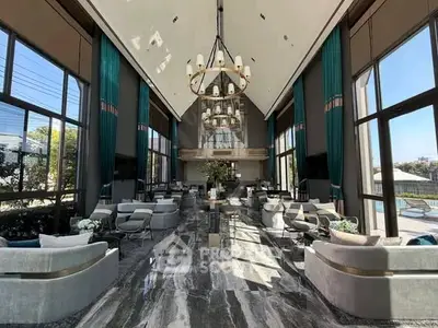 Luxurious modern lobby with high ceilings and elegant seating in a prestigious building.
