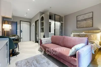 Modern studio apartment with stylish pink sofa and open layout