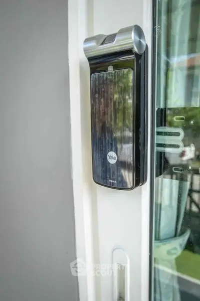 Modern smart lock on a sleek glass door, enhancing home security with style and technology.