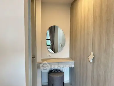 Modern bedroom with stylish vanity and large wardrobe, perfect for urban living.