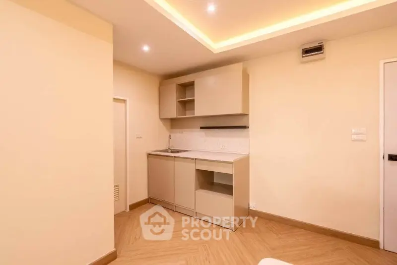 Modern minimalist kitchen with sleek cabinetry and recessed lighting