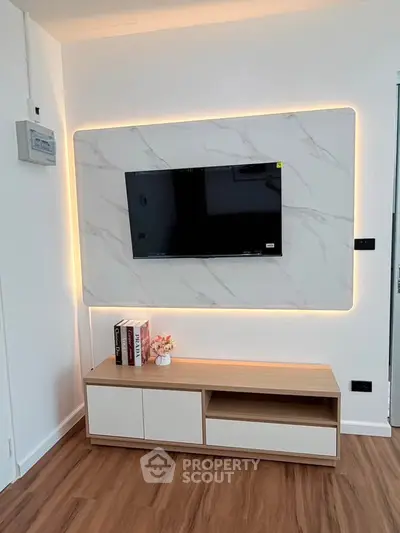 Modern living room with stylish TV wall mount and wooden flooring