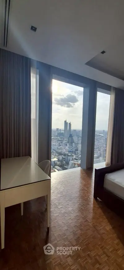 Luxurious bedroom with stunning city view from high-rise apartment, featuring elegant parquet flooring.