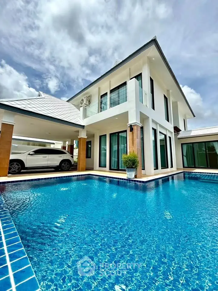 Luxurious modern villa with private pool and carport, perfect for upscale living.