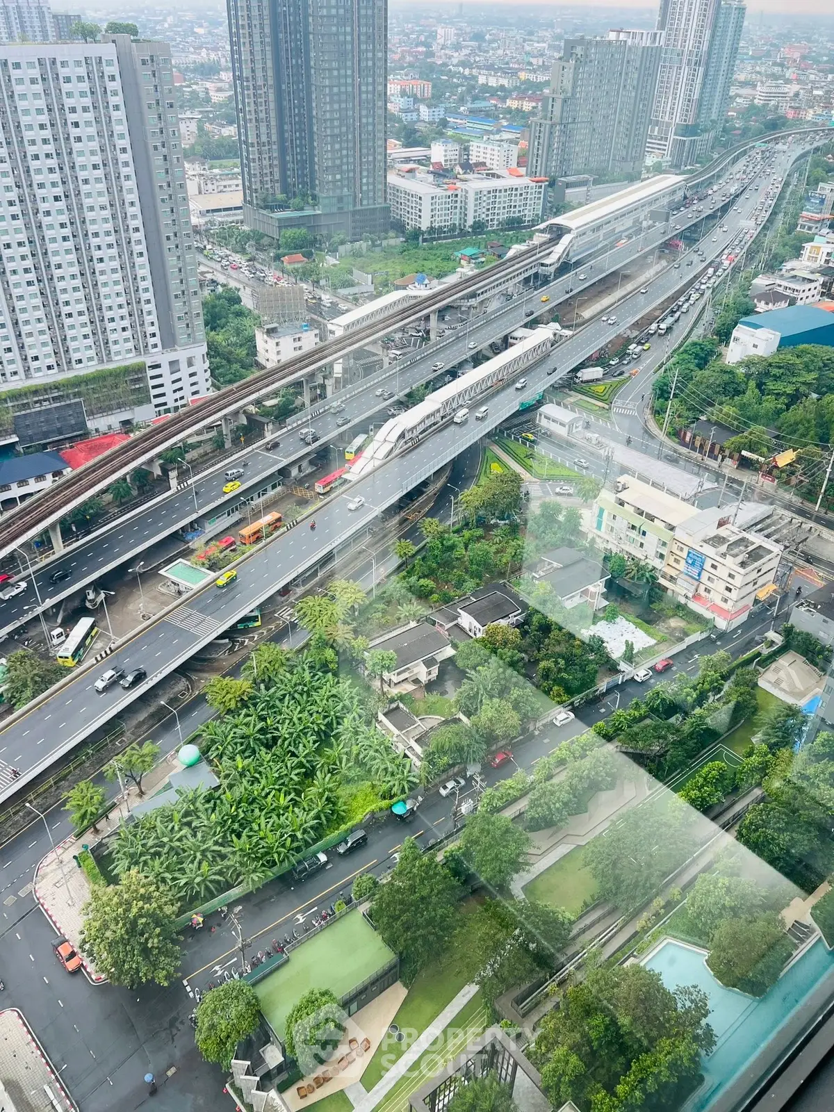 Stunning aerial view of urban landscape with high-rise buildings and busy roads.