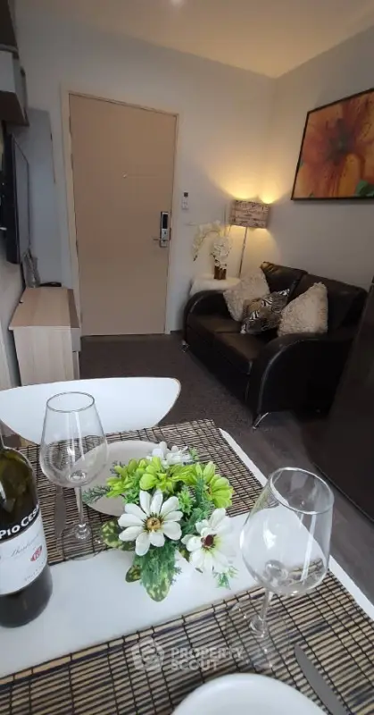 Cozy living room with elegant decor and dining setup, perfect for relaxation.