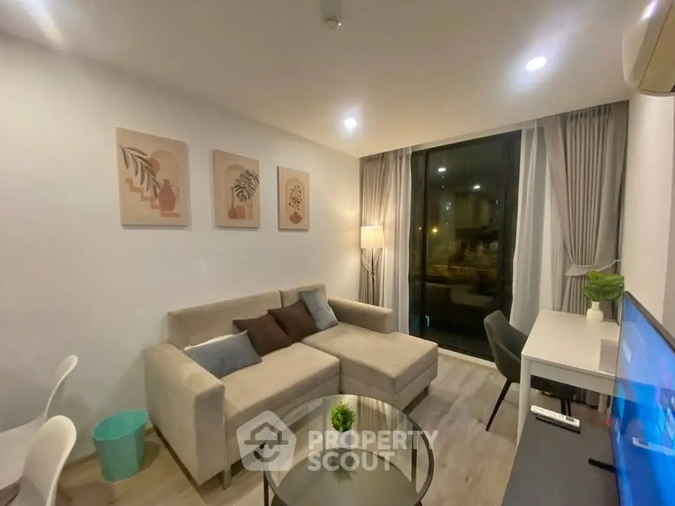 Modern living room with cozy sectional sofa and stylish decor in a well-lit apartment.