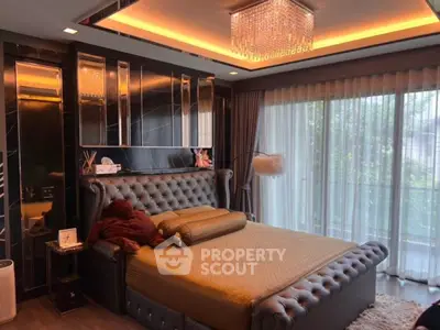 Luxurious bedroom with elegant decor and large windows offering natural light.