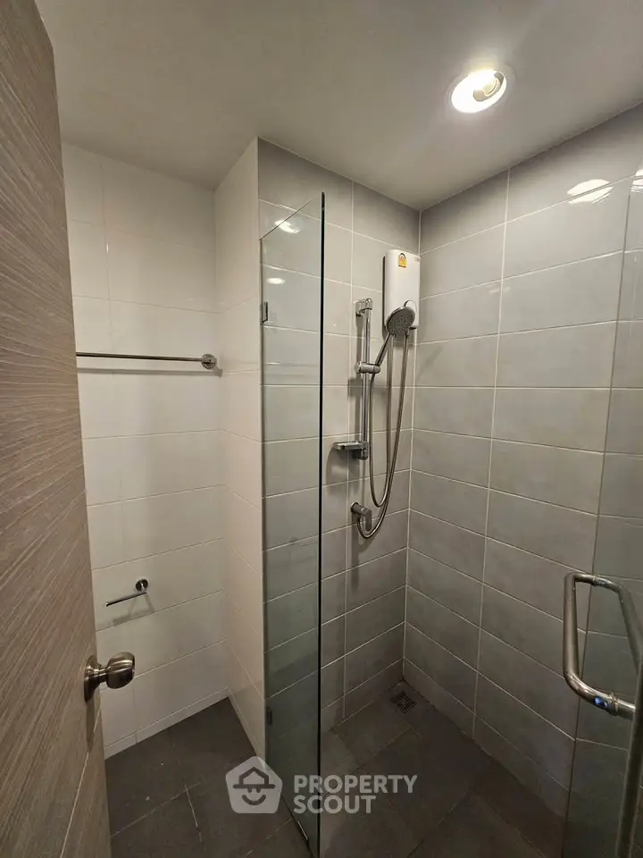 Modern bathroom with glass shower enclosure and sleek tile design