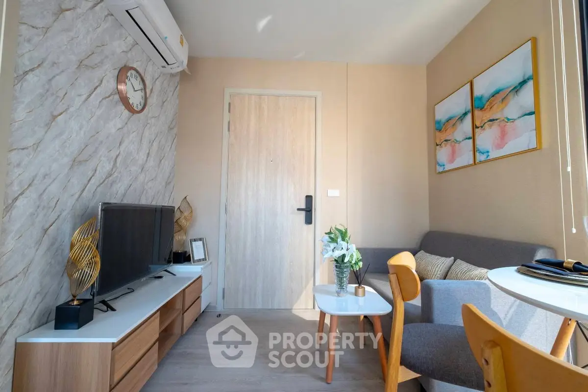 Cozy living room with modern decor and natural light, featuring a stylish sofa and wall art.