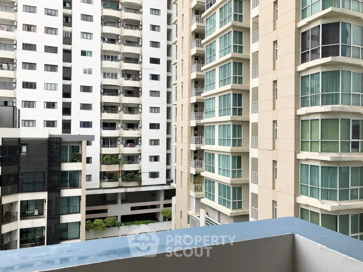 Modern high-rise apartment buildings with balconies and large windows.