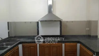 Modern kitchen with sleek gas stove and wooden cabinets, perfect for culinary enthusiasts.
