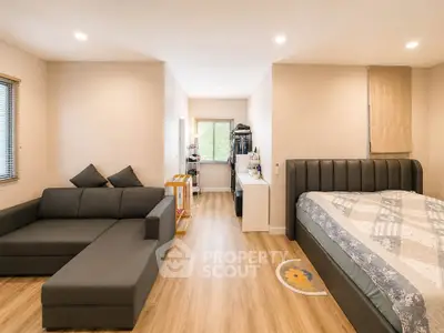 Spacious modern bedroom with cozy seating area and stylish decor