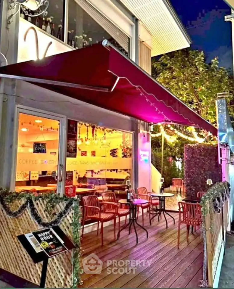 Charming outdoor cafe with cozy seating and ambient lighting, perfect for evening relaxation.