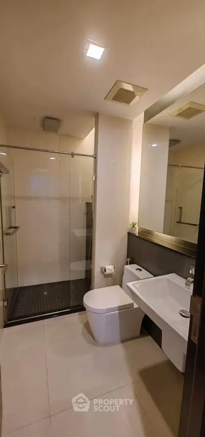 Modern bathroom with sleek fixtures and glass shower enclosure