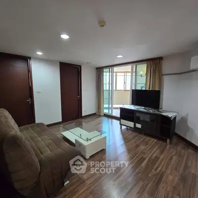 Spacious living room with modern decor and glass coffee table