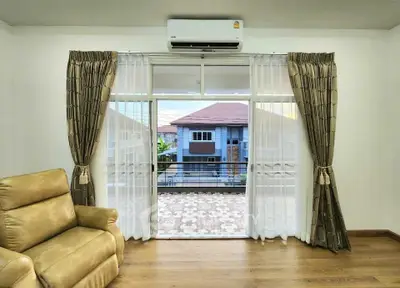 Spacious living room with balcony view and modern decor