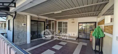 Spacious covered patio with modern tile design and sliding glass doors.