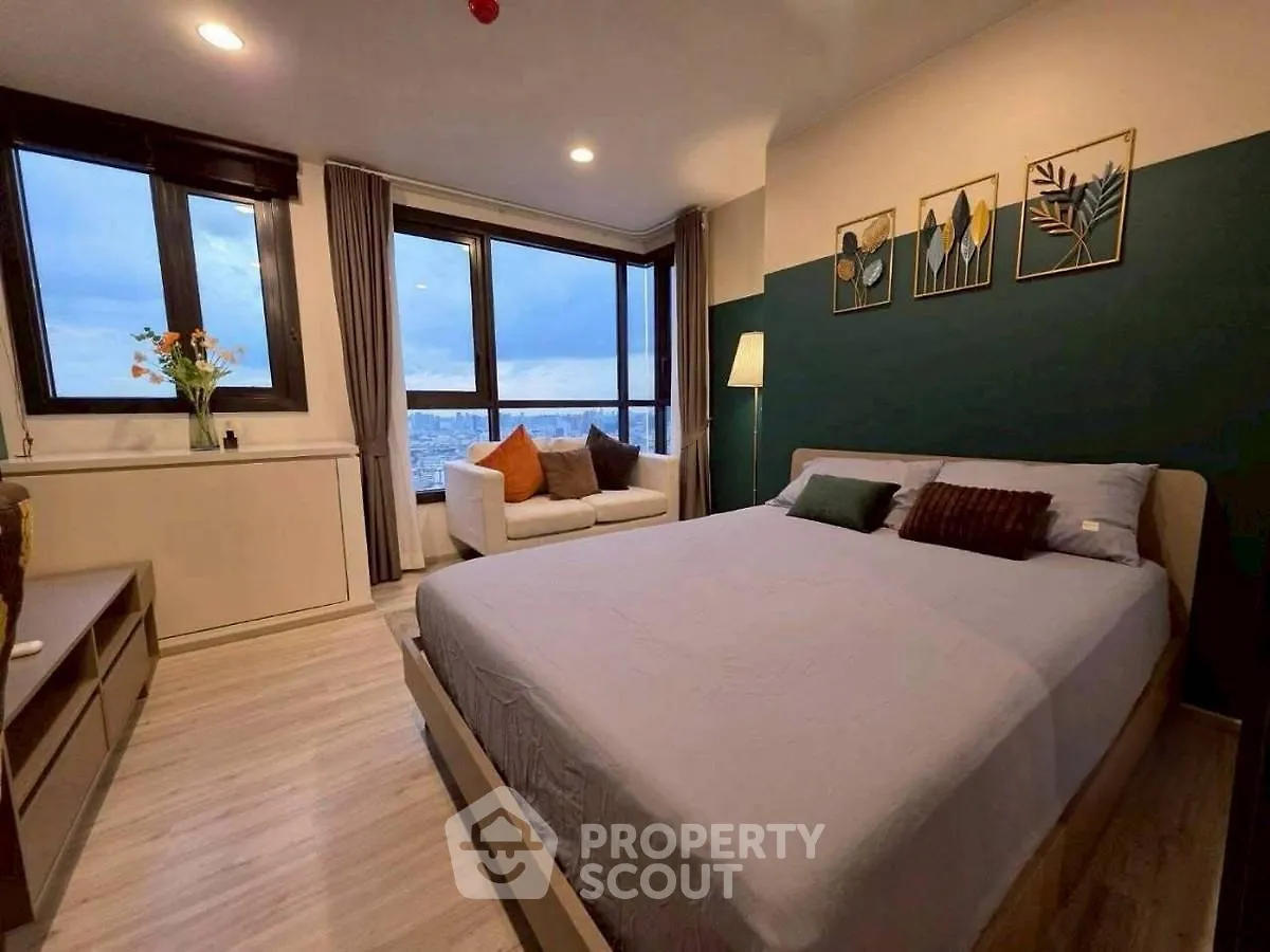 Spacious bedroom with city view and modern decor