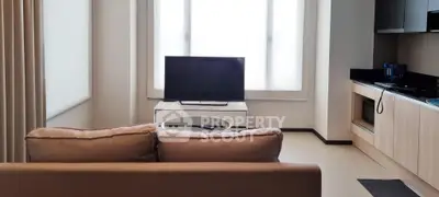 Modern living room with sleek furniture and large window, perfect for relaxation and entertainment.