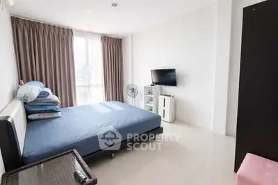 Spacious bedroom with modern decor and natural light