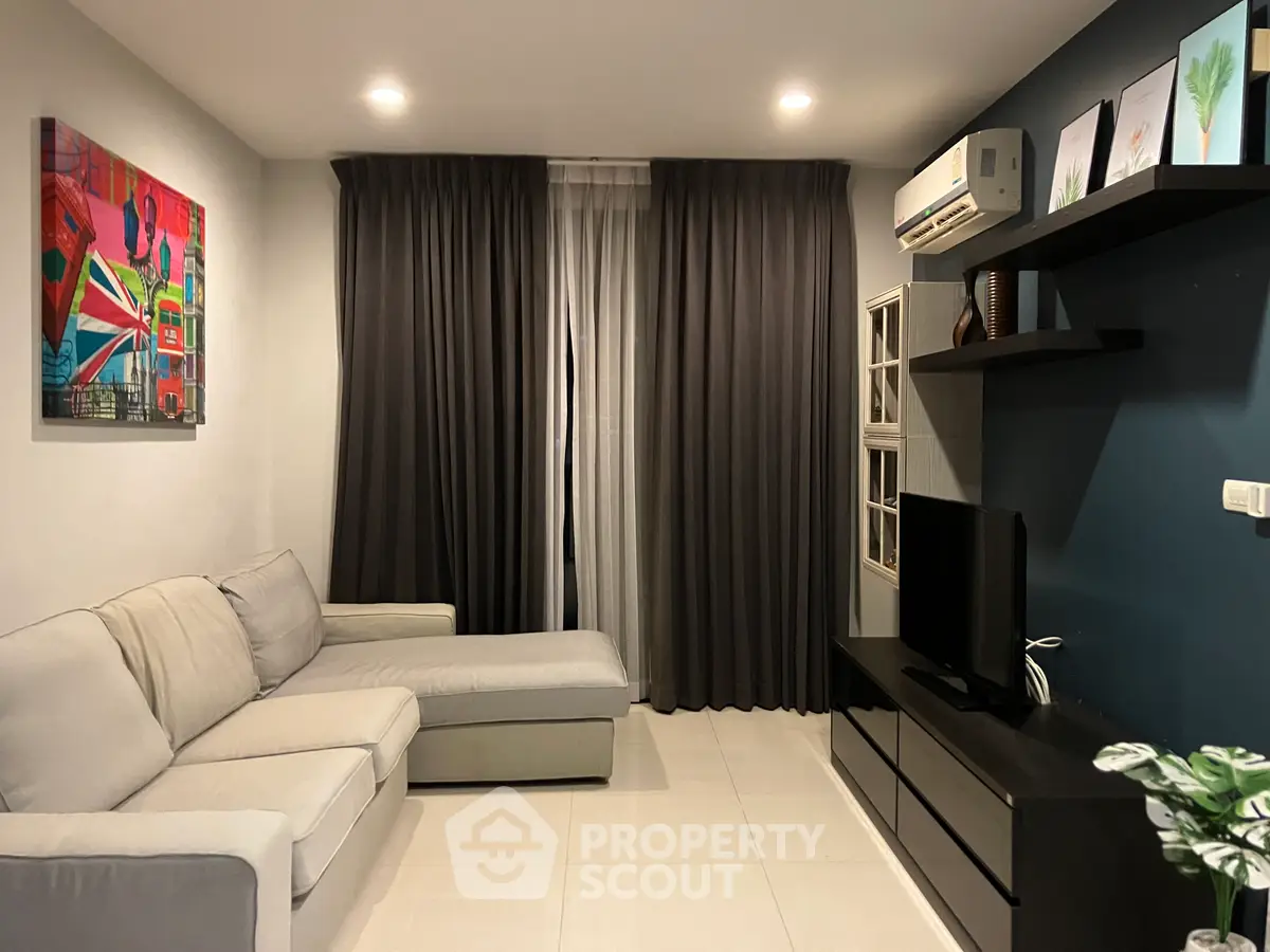 Modern living room with sleek furniture and stylish decor, featuring a comfortable sectional sofa and wall-mounted TV.