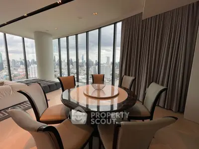 Luxurious high-rise apartment with panoramic city views and elegant dining area.