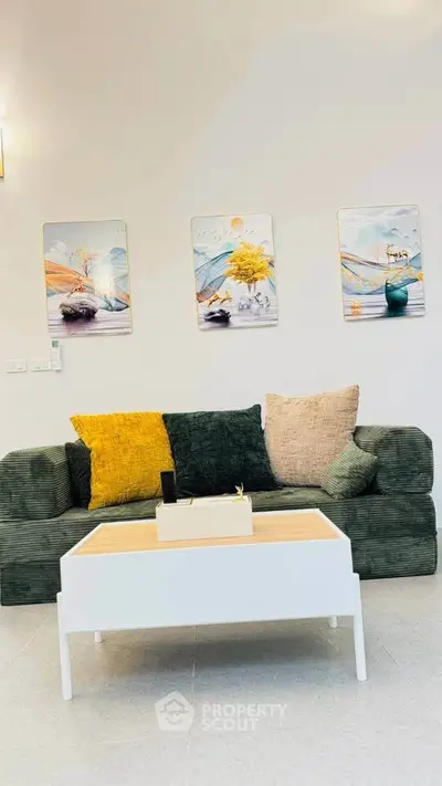 Stylish living room with modern sofa and decorative wall art, perfect for cozy relaxation.