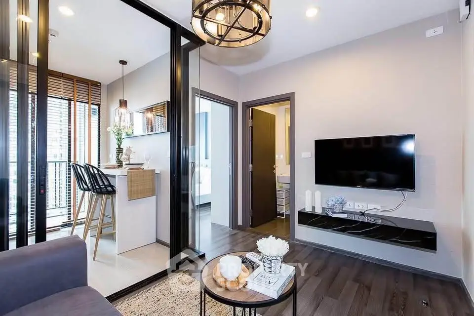 Modern living room with sleek design, open kitchen layout, and stylish decor in a contemporary apartment.
