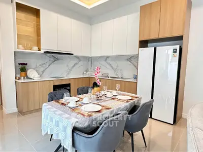 Modern kitchen with elegant dining setup and sleek appliances