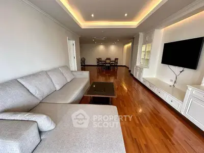 Spacious living room with elegant wooden flooring and modern furnishings