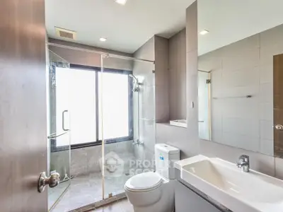 Modern bathroom with glass shower and sleek fixtures