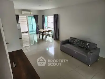 Spacious living room with modern furniture and large windows for natural light.