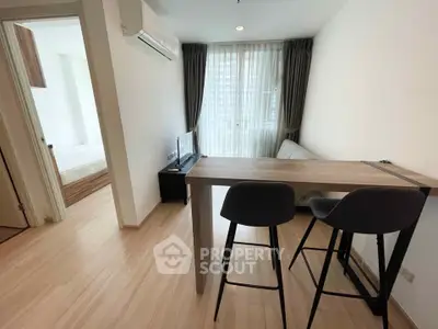 Modern living room with sleek furniture and natural light in a stylish apartment.