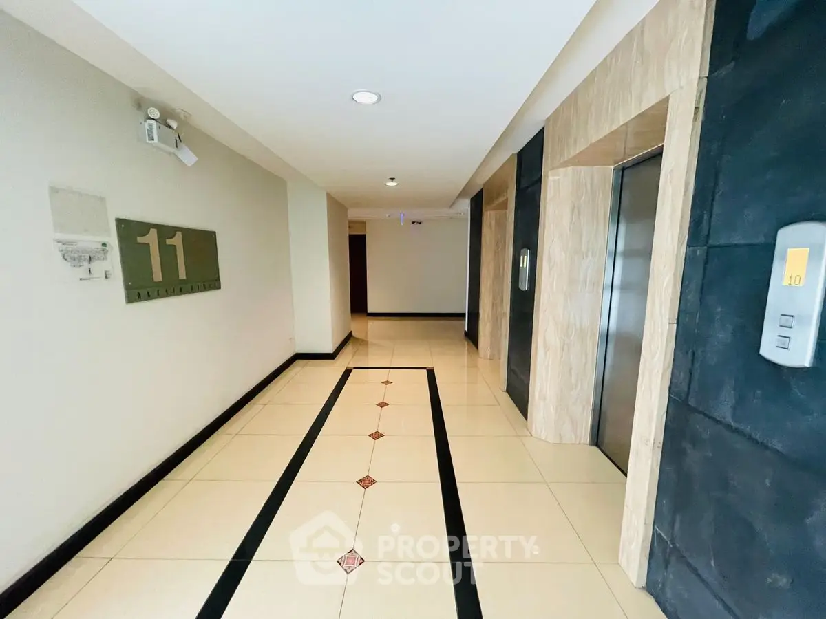 Modern apartment building hallway with elevator access on the 11th floor.