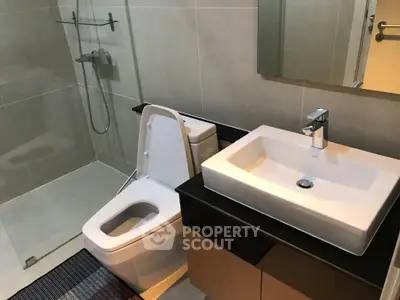 Modern bathroom with sleek fixtures and glass shower enclosure