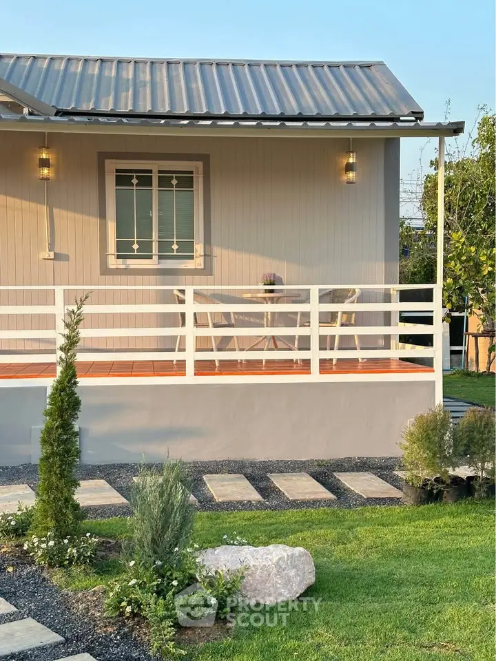 Charming modern home with inviting front porch and landscaped garden, perfect for relaxation and outdoor enjoyment.