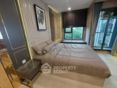 Luxurious bedroom with modern decor and large windows offering a serene view.