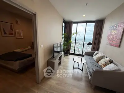Modern living room with stunning city view and cozy bedroom in a high-rise apartment.