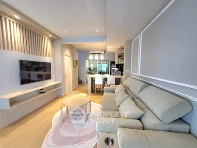 Modern living room with stylish decor and open kitchen layout