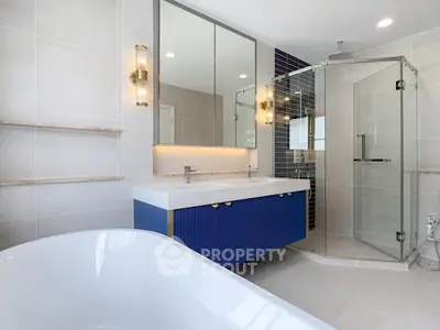 Luxurious modern bathroom with elegant fixtures and spacious shower area.