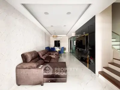 Spacious modern living room with elegant brown sofa and sleek entertainment unit