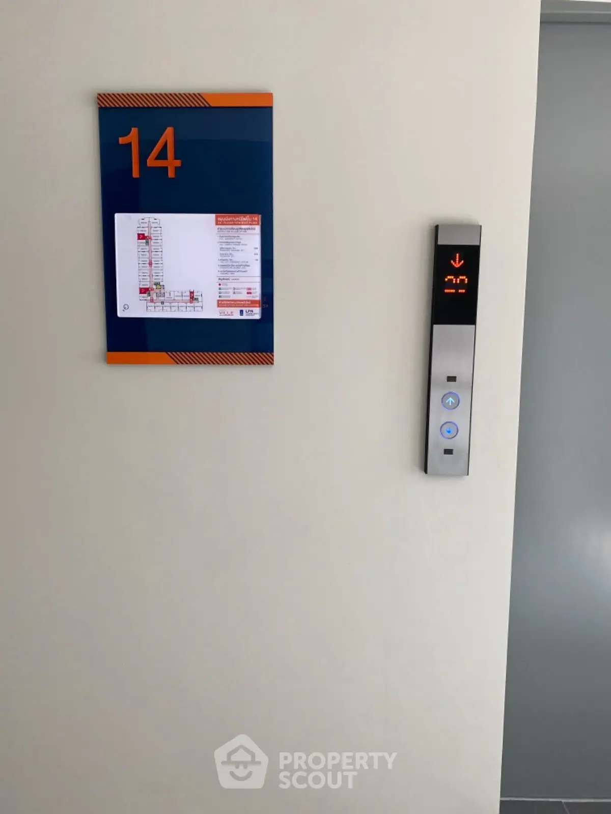 Modern elevator panel on 14th floor with floor plan signage.