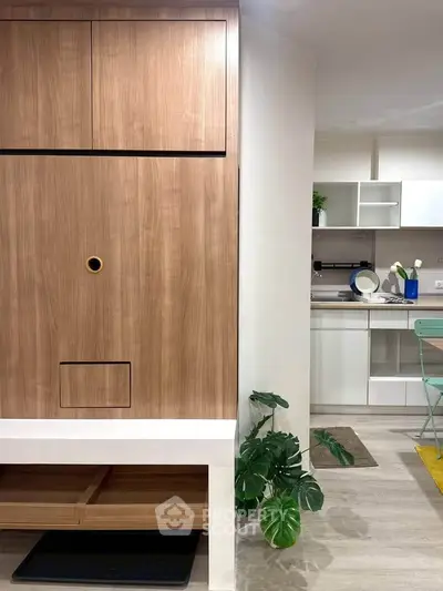 Modern kitchen with sleek cabinetry and stylish decor in a contemporary apartment.