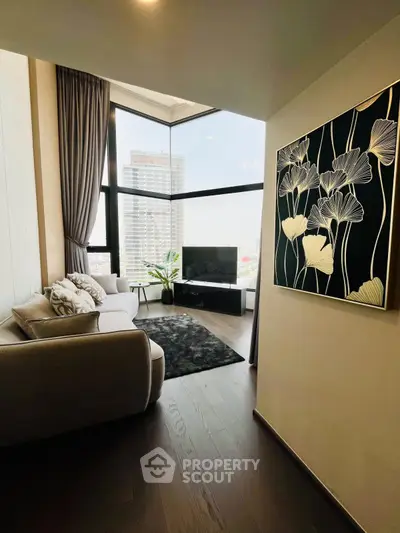 Stylish modern living room with large windows and elegant decor in a high-rise apartment.